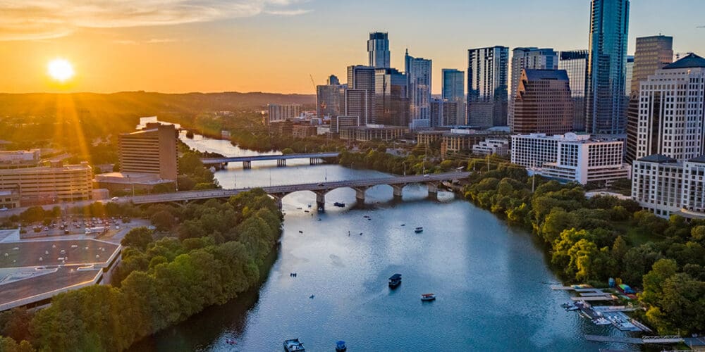 Contact - Beautiful Aerial View of Downtown Austin, Texas With a Sunrise in the Background